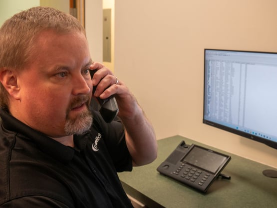 Omaha IT support on the phone helping a client with network monitoring, phone systems, cybersecurity, or IT help desk